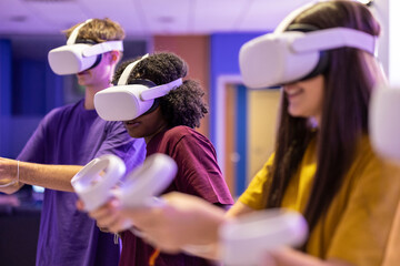 group of multicultural friends gamers with virtual reality glasses playing video games