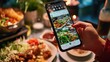 Woman taking photo of salad with smartphone at restaurant. Food blogger concept