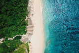 Fototapeta  - Paradise beach with turquoise ocean and resort in Bali. Aerial view