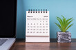 March 2024 desk calendar and potted plant