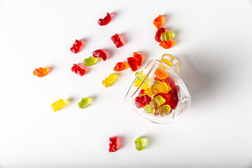 Tasty gummy jelly bears, isolated on white background. Colorful gummy jelly bears in a transparent glass cup