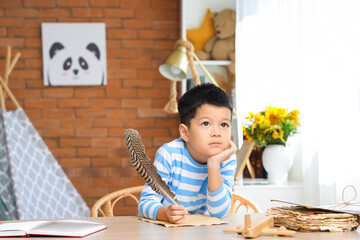 Sticker - Cute little boy with adventure book writing at home