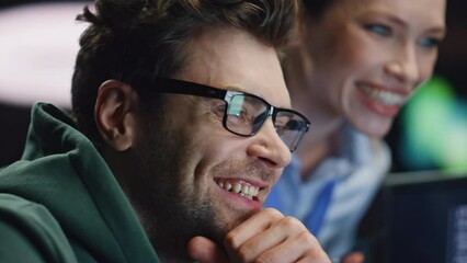 Happy excited colleagues laughing celebrating work success late office closeup