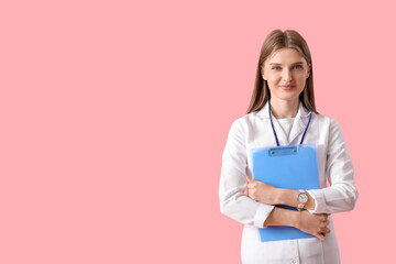 Wall Mural - Beautiful doctor with clipboard on pink background