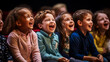 © XaMaps - A group of children laughing during a comedic theater performance.