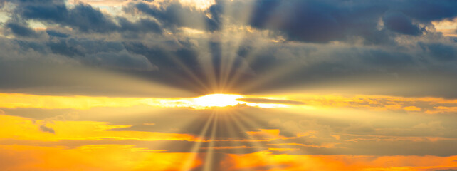 Wall Mural - sunset sky panorama with sunset clouds, sun rays and dramatic sky
