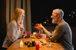Loving mature man proposing his girfriend during romantic dinner in the kitchen