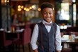 © vasyan_23 - happy african american child boy waiter in restaurant, cafe or bar