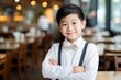 © vasyan_23 - happy asian child boy waiter in restaurant, cafe or bar