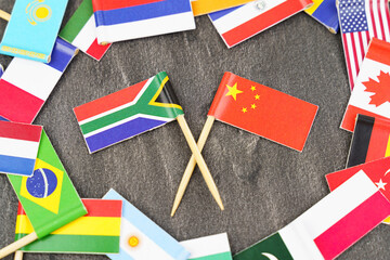 The concept is diplomacy. In the middle among the various flags are two flags - China, South Africa