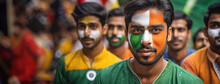 Patriotic Faces In A Crowd Celebrating Indian Independence. A Group Of Indian Men With Painted Faces In The Colors Of India's Flag Stands Together, Symbolizing Unity And National Pride