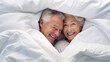 A playful elderly couple, peeking out from under a crisp white duvet, their eyes sparkling with mischief and joy.