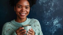 Portrait Of Happy Young Woman With Cup Of Coffee Isolated On Navy Background With Copy Space, Smiling African American Woman In Mint Green Sweater Holding Coffee Mug And Enjoy Herself.