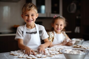 Two children brother sister laughing smiling home kitchen cook bake cookies sweets together funny kids apron preparing girl boy happy family dessert little baby enjoy ingredients pastry son daughter