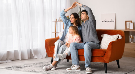 Wall Mural - Happy family dreaming about their new house at home