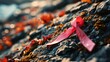 © progressman - a pink ribbon on a rock