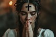 The symbol of a cross made of ashes on praying woman's forehead for Ash Wednesday