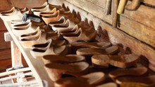 A Collection Of Vintage Wooden Clogs On The Wooden Table