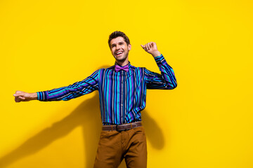 Poster - Portrait of optimistic guy dressed stylish shirt bow tie dancing look at sale empty space isolated on bright yellow color background