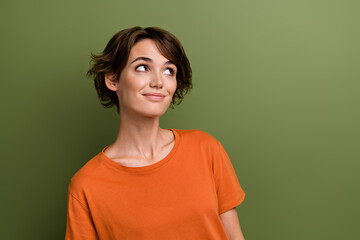 Sticker - Photo of satisfied girlish woman with bob hairstyle dressed orange t-shirt look at discount empty space isolated on green color background