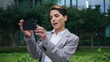 © stockbusters - Smiling manager recording video on smartphone at downtown. Relaxed woman enjoy