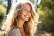 Portrait of a young smiling woman with blond long hair, happiness and joy