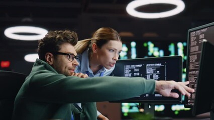 Programmers couple working together in dark room closeup. Analysts discussing
