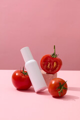 Wall Mural - Concept of organic fruit with fresh tomatoes decorated with an unbranded bottle. Container packaging of skin care branding with Tomato extract