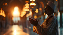 Muslim Man Praying With Hands Open Palm Up  At Mosque During Month Of Ramadan. Blurred Arch With Sunbeam Background,