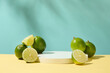 Fresh lemons are placed next to a white podium on a pastel background. The acid in lemon has antibacterial and astringent effects that help remove blackheads on the face gently and effectively.