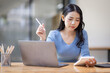 © David - Asian Business woman using calculator and laptop for doing math finance on an office desk, tax, report, accounting, statistics, and analytical research concept