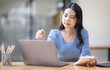 © David - Asian Business woman using calculator and laptop for doing math finance on an office desk, tax, report, accounting, statistics, and analytical research concept