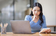 © David - Asian Business woman using calculator and laptop for doing math finance on an office desk, tax, report, accounting, statistics, and analytical research concept