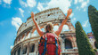 Realistic image of female tourists raising their hands in joy with the background of the Colosseum, Italy, Italy tourism concept.