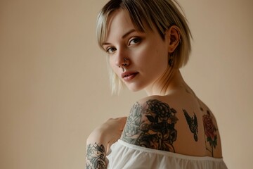 Wall Mural - a woman with tattoos on her shoulder