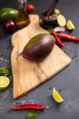 Wall Mural - Tropical mango fruit on a wooden cutting board