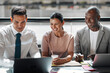 © Flamingo Images - Smiling group of diverse businesspeople working at a table together