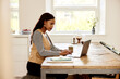 © Flamingo Images - Businesswoman using a laptop at home