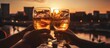 Group of people's hands toasting with a glass of drink at sunset. Close up shot.