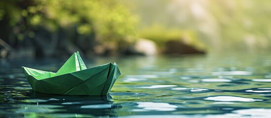 Clean energy for sea and cargo transportation and travel and sustainable maritime transport concept Paper boat emitting fresh green leaves. with copy space image. Place for adding text or design