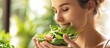 Attractive woman with a healthy lifestyle eating a bowl of salad Young woman eating her greens. with copy space image. Place for adding text or design