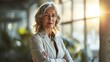 © WS Studio 1985 - Portrait of mature business woman with arms crossed looking at camera. Happy smiling mid businesswoman standing in office