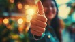 Thumbs up, blurred, and a working woman agree by making a cheerful hand sign. Employees like and smile when they hear that they have achieved their highest professional career goal at work. 