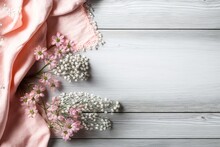Hello Spring Concept. Top View Photo Of Pink Soft Plaid And Gypsophila Flowers On Grey Wooden Table Background With Copyspace, Generative AI