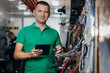 © andrew_shots - Young engineer check and restores electrical wiring from tractor