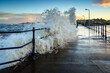 Large Wave breaks onto Amble Pier.  Amble Harbour is actually called Warkworth Harbour and is set on the banks of the River Coquet in Northumberland in the North East of England