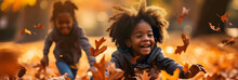 Black Kids Playing In Autumn Leaves On A Sunny Day