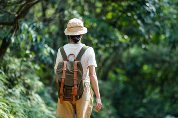 Sticker - Woman walk along the hiking trail in the forest