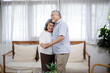 © winnievinzence - Asian senior couple embracing enjoy dancing and smiling together in the living room. Retired people do activity at home. Love and bonding of grandparents. Healthy living and insurance concept