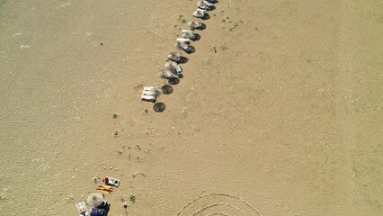 Wall Mural - Drone shooting on the beach and down to the sea. Beaches and people swimming in the sea in summer. Çıralı, Antalya coast in the summer of 2023. 4K coast and beach shots.